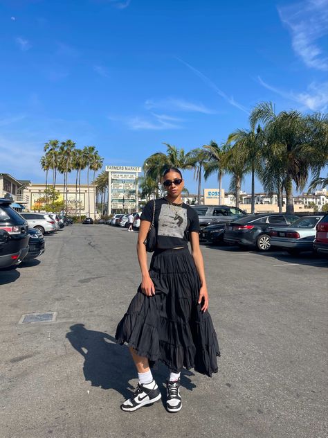 Graphic Tee Black Skirt Outfits, Long Skirt Outfits Graphic Tee, T Shirt With Flowy Skirt, Black Skirt And Graphic Tee Outfit, Dunk Low With Dress, Pleated Skirt Outfit Street Style, Black Layered Skirt Outfit, Boho Black Skirt Outfit, Panda Inspired Outfit