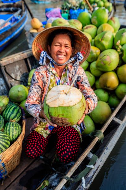 Vietnamese woman selling coconuts on floating market, Mekong River Delta, Vietnam Nature, Market Reference Photo, Phuket Market, Green Investment, Riverside Market, Vietnam People, Book Illustration Layout, Street Food Market, Mekong River