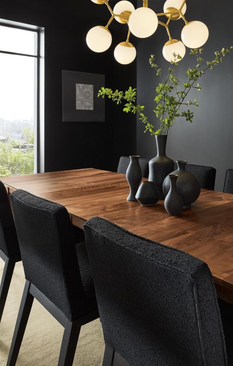 Dining room with Adams extension table, Ansel side chairs and Cosma chandelier. Dark Moody Dining Room, Moody Dining Room Ideas, Dark Blue Dining Room, Moody Dining Room, Black Dining Room Table, Black Round Dining Table, Dining Room Accent Wall, Black Kitchen Table, Black Walnut Table