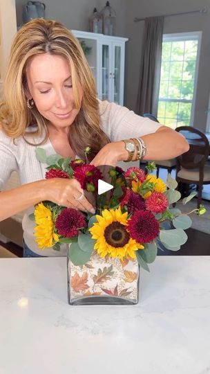 955K views · 12K reactions | Fall Napkin Floral Arrangement 💛 Achieve a professional floral designer look with this affordable autumn-themed vase bouquet that's versatile for any season or holiday!I lined my larger vase with a festive fall printed paper dinner napkin, adding a warm and vibrant touch to complement both the flowers and my golden autumn theme. Using the popular tape grid method with my smaller interior vase, I arranged store bought sunflowers, mums, dahlias and eucalyptus- into a sophisticated arrangement. No more slouchy flowers!This arrangement would make for a perfect hostess gift, fall gathering centerpiece or autumn birthday present. #fallfloralarrangement #falldiy#fallflowers #fallweddings #sunflowers | Janine Graff | Janine Graff · Original audio