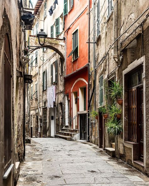 A beautiful historic street in the old town in Ventimiglia, Italy. This coastal city in Liguria is an underrated gem on the Italian Riviera. Click through for more pictures on A Lady in London’s Instagram.   #ventimiglia #liguria #italy #oldtown Ventimiglia Italy, Valencia Old Town, Old City Street, Plakat Design Inspiration, Stockholm Old Town, Warsaw Old Town, Dubrovnik Old Town, Italy Street, Dalmatian Coast