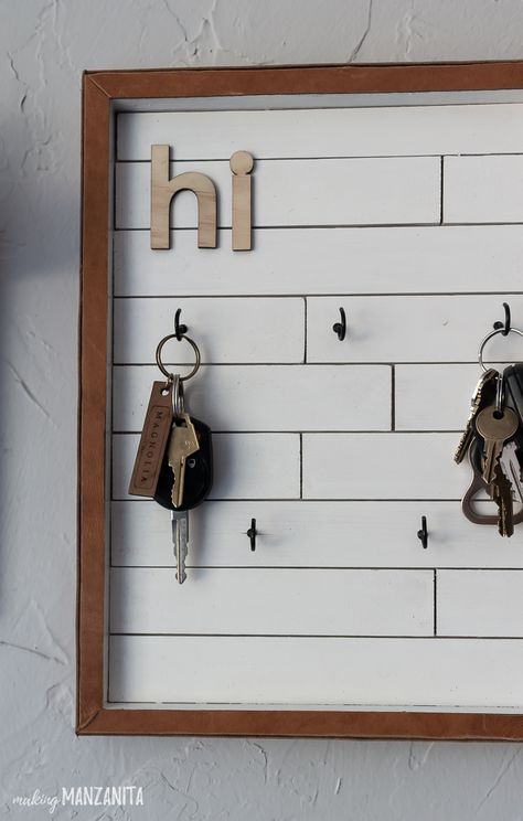 No more searching for keys all over the house. This DIY key holder turned out so cute! Can you believe it was made from a thrifted sign, paint sticks and recycled leather and NO nails?  #entryways #keyholder #homedecor Entry Key Holder Ideas, Entry Shelf With Hooks, Small Entry Way Ideas, Key Rack Diy, Entry Way Ideas, Small Entry Way, Diy Key Holder, Key Holder Diy, Diy Shoe Storage