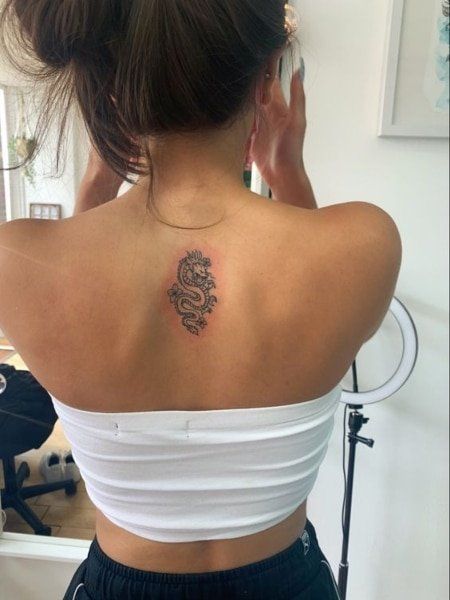 25 Coolest Back Tattoos for Women (2021)- The Trend Spotter Coolest Back Tattoos, Dragon Tattoo With Flowers, Back Tattoos For Women, Small Back Tattoos, Cool Back Tattoos, Upper Back Tattoos, Dragon Tattoo For Women, Muster Tattoos, Spine Tattoos For Women