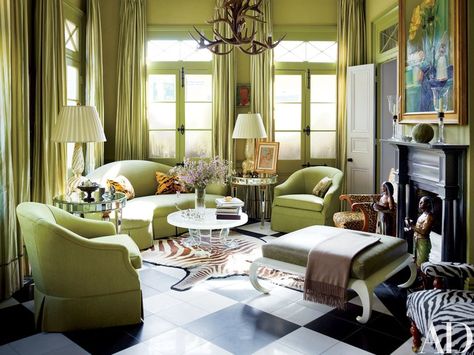 In the living room a still life hangs above the mantel; the William Haines cocktail table once belonged to actress Claudette Colbert. The sofa is clad in a Rubelli linen from Donghia; the ottoman, from Duane, is upholstered in an Edelman leather, and the mirrored tables and zebra rug are from Vol. 1 Antiques. Las Vegas, New Orleans Homes Interior, New Orleans Bedroom, New Orleans Interior Design, Sage Living Room, Glamorous Room, Creole Cottage, New Orleans Style, Glamorous Decor