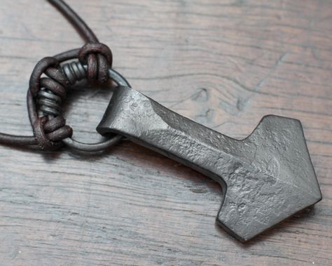 This is a Mjolnir necklace for those of you who prefer a less ornate look, something with unique character that can only be forged with hammer that is not cast in its thousands.  It is an ancient symbol for luck made for those of you who love and honour Thor.  We have forged this Thor's hammer pendant out of pure iron, using traditional tools and methods. The simple design was created by our love of Viking history and our experience as re-enactors. In this Thor's hammer we have combined traditio Blacksmithing Ideas, Mjolnir Pendant, Iron Jewelry, Norse Pagan, Viking Pendant, Thor's Hammer, Electroformed Jewelry, Hand Forged Iron, Thors Hammer