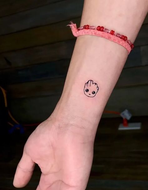 25 Awesome Baby Groot Tattoo Ideas In 2022 14 Groot Minimalist Tattoo, Tv Show Tattoos Minimalist, Avengers Small Tattoo, Marvel Rocket Tattoo, Small Guardians Of The Galaxy Tattoo, Groot Tattoo Small, Cool Marvel Tattoos, Marvel Small Tattoo Ideas, Mini Marvel Tattoo