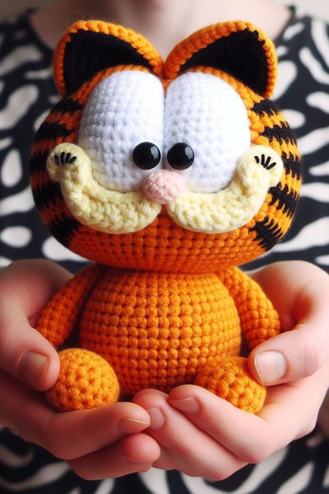 Nestled amongst the cozy skeins of vibrant yarn, the Garfield amigurumi brings the sass and charm of the world's favorite orange tabby cat to life. Garfield Amigurumi Free Pattern, Crochet Garfield Amigurumi, Winnie Pooh Crochet Pattern Free, Amigurumi One Color, Garfield Crafts For Kids, Crochet Garfield Pattern Free, Garfield Crochet Pattern Free, Crochet Amigurumi Pattern Free, Garfield Crochet