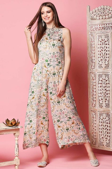 Featuring a light beige jumpsuit in cotton satin base with floral print and 3D floral embellishment.  FIT: Fitted at bust and waist. COMPOSITION: Cotton satin. CARE: Dry clean only. Jumpsuit Indian, Ruffled Saree, Jumpsuit Design, Beige Jumpsuit, Set Saree, Floral Embellishment, Saree Gown, Designer Jumpsuits, Sharara Set