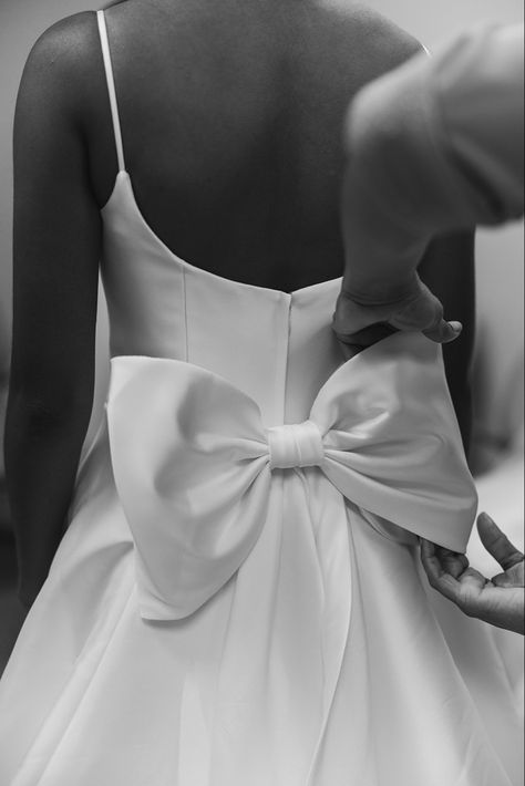 wedding dress bow wedding details dress inspo bridal look High Neck Wedding Dress With Bow, Black Bow Wedding Dress, White Dress Big Bow, Wedding Dress Bows On Back, Short White Dress With Big Bow, Bow Behind Dress, Detachable Bow Wedding Dress, Wedding Dress Satin With Bow, Simple Wedding Dress Bow Back