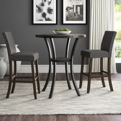 Be it everyday meals with the family or casually catching up with close friends over coffee, this five-piece dining set is the perfect pick for your abode. The included table features four legs, a circular tabletop, and decorative nailhead trim in the color bronze. The two matching chairs all showcase an espresso finish down below and are upholstered with cotton and linen awash in a near-neutral color. Color: Gray | Bistro Table - Greyleigh™ Haysi 2- Person Bar Height Dining Set Wood/Metal in Gr Kursi Bar, Wood Table Bases, Table Bistrot, Bar Table Sets, 3 Piece Dining Set, Solid Wood Dining Set, Pub Table Sets, Counter Height Dining Sets, 5 Piece Dining Set