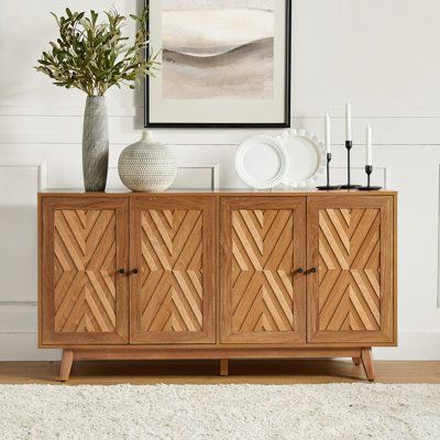 This mid-century-inspired sideboard brings plenty of vintage charm to your living room or dining area. The frame is made from engineered wood with a rustic finish, and it showcases a chevron-patterned inlay on the front with contrasting dark handles. With four doors and three adjustable shelves, it offers versatile storage solutions to accommodate your needs. The poplar wood legs with adjustable feet not only add to its retro appeal but also help keep it level. Designed to hold up to a 70" flats Mid Century Vintage Living Room, Dining Room Buffet Styling, Modern Spanish Decor, Natural Sideboard, Sideboard Decor Dining Room, Sideboard Living Room, Retro Dining Room, Modern Kitchen Layout, Living Room Sideboard