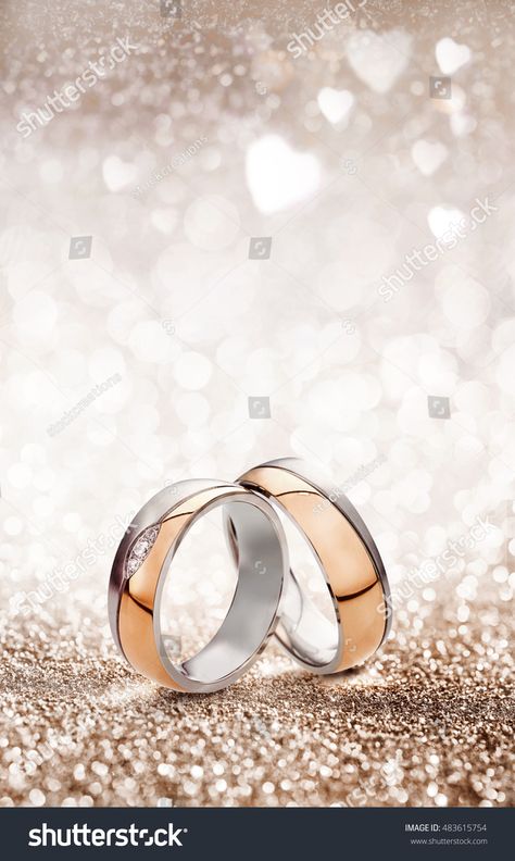 Romantic wedding ring celebration background with two gold rings balancing upright over a light sparkling background with white hearts and copy space for an invitation or greeting card Wedding Ring Background, Best Wedding Rings, Romantic Wedding Rings, Antique Style Engagement Rings, Dream Wedding Ring, Wedding Invitation Background, Engagement Rings Twisted, Rings Ceremony, Celebration Background