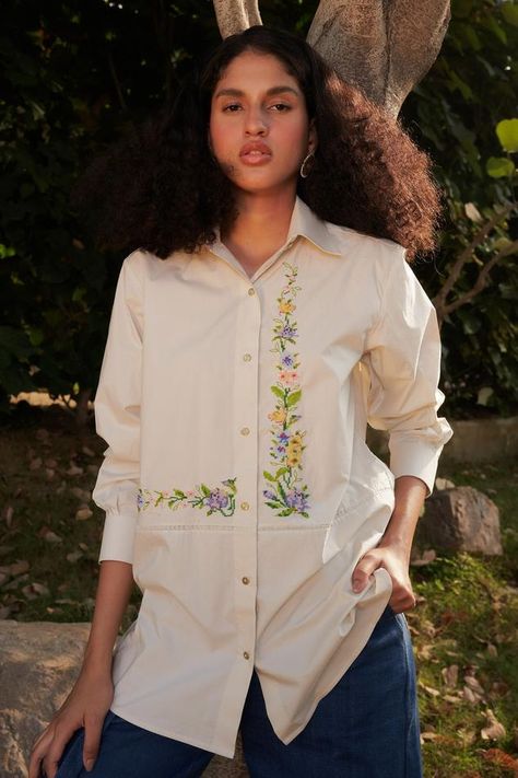 Beige shirt with lace work panel and floral cross stitch embroidery. Components: 1 Pattern: Embroidered Type Of Work: Floral Neckline: Shirt Collar Sleeve Type: Cuff Fabric: 100% cotton poplin Color: Beige Other Details:  Length approx. (in inch): 30 Weight (in gms): 500 Closure: Front buttons Note: Pant worn by the model is not for sale  Occasion: Work - Aza Fashions Embroidery Shirt Men, Floral Embroidery Top, Embroidered Shirt Dress, Stylish Shirts Men, Beaded Shirt, Fashionable Saree Blouse Designs, Hand Beaded Embroidery, Beige Shirt, Men Fashion Casual Shirts