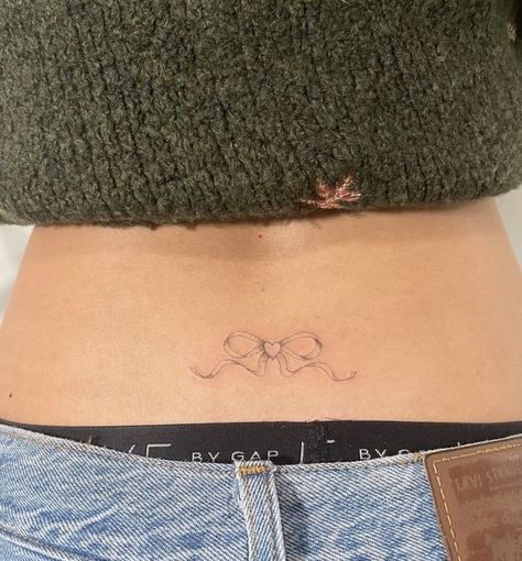 Womens Waist Tattoos, Hip Tattoo Dainty, Small Coquette Tattoos, Coquette Tramp Stamp, Croquette Tattoo, Coquette Tattoo Ideas, V Line Tattoos Women, Coordinating Tattoos, Cute Tramp Stamp Tattoos