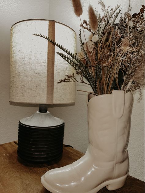 Western Console Table Decor, Rustic Room Decor Bedroom Country, Tv Stand Decor Western, Western Family Room Ideas, Country Aesthetic Living Room, Western Side Table Decor, Boot Vase With Flowers, Western Bathroom Counter Decor, Western Aesthetic Home Decor