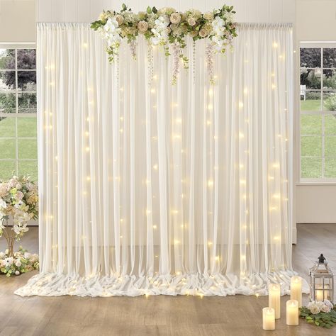 PRICES MAY VARY. Package included: 2 panels tulle backdrop +1 set light +10pcs Transparent clips, 5ft width by 10ft height covering a total area of 10ft width by 10ft height, You can buy more if you want more of a fuller look and less sheer Semitransparent Sheer: The fabric is so dreamy. it’s like a semi sheer dress that flows in the wind so had a very romantic effect. also lightweight to wear the wind was able to blow it for a dramatic effect. Simple and Elegant Design: You can put curtain ligh Diy Party Wall Backdrop, Curtains With Lights, Mother's Day Photo Backdrop, Grad Party Photo Backdrop, Baby Shower Backdrop Ideas, Photo Backdrop Ideas, Sheer Backdrop, Tulle Lights, Tulle Backdrop