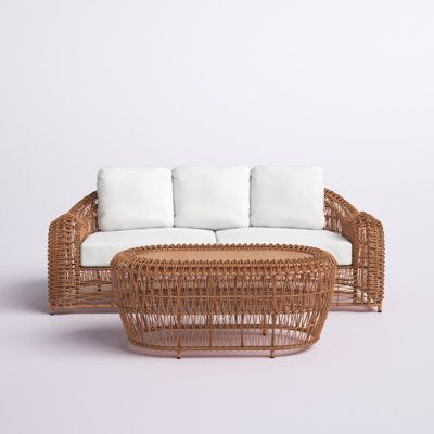 This patio seating group set instantly creates an outdoor living room with a breezy, coastal aesthetic. It includes one 3-person sofa and one coffee table with a circular shape and wooden tabletop. The sofa frame is crafted from aluminum into a retro-inspired silhouette with gently sloping arms wrapped in all-weather HDPE wicker in a neutral hue. We love that it also comes with all the foam cushions you need in a clean white hue made from Sunbrella fabric that's resistant to water and fading. Pl Cute Outdoor Furniture, Wicker Sofa Living Room, Brickell Apartment, Breezy Aesthetic, Metal Building House Plans, Wicker Couch, Earthy Home, Coastal Aesthetic, Outdoor Bistro Set