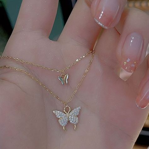 This beautiful necklace features a delicate double layer design with two butterfly pendants. It's perfect for adding a touch of whimsy and sophistication to your look. https://belsizecrafts.com/products/double-layer-butterfly-pendant-necklace #UKJewelry #UKFashion #BritishMade #UKSmallBusiness #SupportSmallBusiness #ButterflyNecklace #DoubleLayerNecklace #PendantNecklace #FashionNecklace #GiftForHer Teardrop Diamond Necklace, Minimalist Diamond Necklace, Butterfly Necklaces, Simple Pearl Necklace, Teardrop Diamond, Outfit Classy, Custom Initial Necklace, Simple Pearl, Butterfly Pendant Necklace