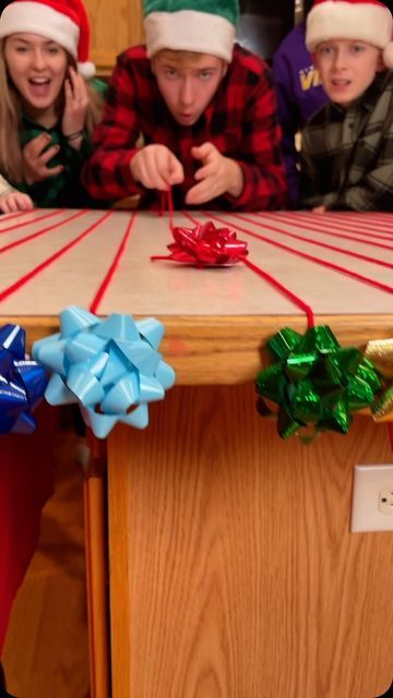 Benson Bros on Instagram: "Best Christmas party game with bows! 🎁 #games #familygames #christmas #familygamenight #christmasparty #reels #partygames #tablegames" Fun Things To Do At A Christmas Party, Benson Brothers Christmas Games, Christmas Contest Ideas, Christmas Games With Gifts, Game Show Party Ideas, Easy Christmas Activities For Kids, Family Holiday Games, Christmas Party Games For Family, Adult Christmas Party Games