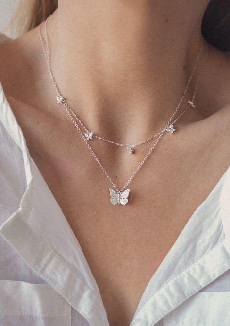 This set consists of 2 sterling silver necklaces, both of which feature butterfly pendants and are fastened at the center back with a round spring clasp, and have a short extension chain. It has: ✅ A delicate chain necklace with a single butterfly pendant attached to the center front of the chain, with intricate detailing on the wings and body ✅ A delicate chain necklace with 5 small butterfly pendants attached to the center front, each pendant made from four zirconia stones.  A dainty and classy duo that will elevate any outfit, including your everyday jeans and tees. Details: ✅ Material: 925 sterling silver, cubic zirconia ✅ Butterfly necklace - length: 42.0 cm (16.53 inches) + 5.0 cm (1.96 inches) length extension; weight: 5.0 g (0.17 oz) ✅ Gemstone multi charm butterfly necklace - leng Necklaces Butterfly, Layering Necklaces, Butterfly Pendant Necklace, Butterfly Pendant, Multi Strand Necklace, Strand Necklace, Multi Strand, Layered Necklaces, Pendant Necklaces