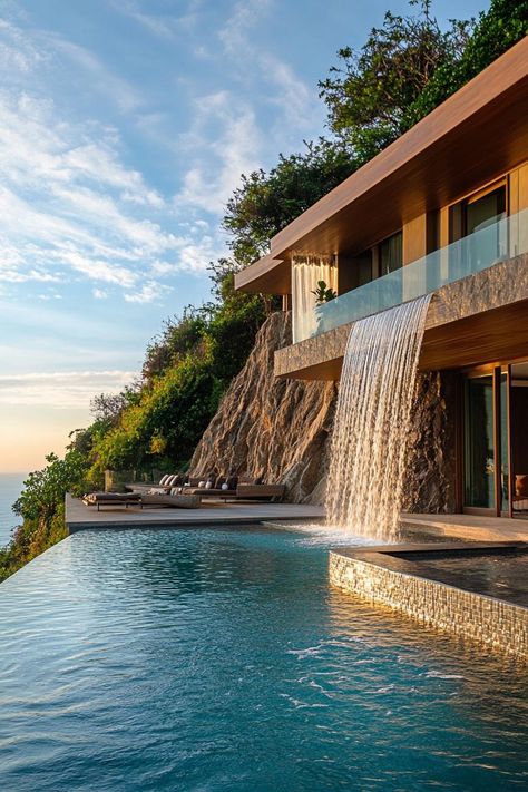 Earth sheltered modern house facade built into hillside with pool with cascading waterfall overlooking a beatiful ocean. Check out all of these stunning houses built into the hillside that look like they belong in a fairy tale. Residential Architecture, Built Into Hillside, Modern House Facade, Cascading Waterfall, Earth Sheltered, House Facade, A Fairy Tale, Fairy Tale, Modern House