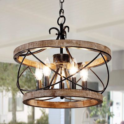 Bring a touch of rustic charm to your home with the 5-Light Rustic Wood Cage Chandelier. Crafted from beautiful birch wood, this chandelier features four candle-shaped lamp bases suspended from wood and an adjustable pendant chain that can extend up to 70 inches. Ideal for both dining and living areas, this chandelier is designed to accommodate sloped ceilings of up to 15 degrees. While the required four bulbs of up to 40 watts each are not included, the chandelier promises an easy setup. It com Farmhouse Chandelier The Home Depot, Wood Farmhouse Chandelier, Rustic Bathroom Chandelier, Rustic Dining Room Lights, Rustic Bedroom Lighting Ceiling, Entryway Lighting Front Entry Farmhouse, Country Kitchen Island Lighting, Pool House Chandelier, Light Fixture Over Round Table