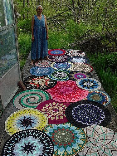 (Note: I didn't take this photo, our friend Barb did)  Sage's mom, who still lives near where we lived in the Ozarks, takes apart peoples' discarded sweaters and reassembles them in to these gorgeous rugs.  I've seen her work for years but not all together like this.  Very striking.    This batch is headed off to be sold at the Midwest Wimmins' Festival.  Thanks to Barb for coming up with the idea for this photo and then making it happen. Gamle T Shirts, Word Mandala, Hantverk Diy, Mandala Crochet, Rug Yarn, Crochet Mandala, Tapestry Crochet, Crochet Rug, Rug Hooking