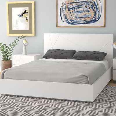 Add a polished, modern feel to your bedroom with this platform bed. It's crafted from engineered wood, and its headboard features carved, geometric accents for visual intrigue. Clean lines keep this piece feeling contemporary, while a neutral finish offers a sleek look to your space and blends effortlessly with a variety of colour schemes. Best of all, this bed comes with a slat kit to support your mattress (sold separately), so there’s no need for a box spring. | Wade Logan Mchenry Platform Bed Bed Design White Colour, White Modern Bed Frame, Bed Frame Ideas Modern, White Bedframe, Modern White Bed, White Platform Bed, Platform Bed Wood, Upholstered Sleigh Bed, White Bed Frame