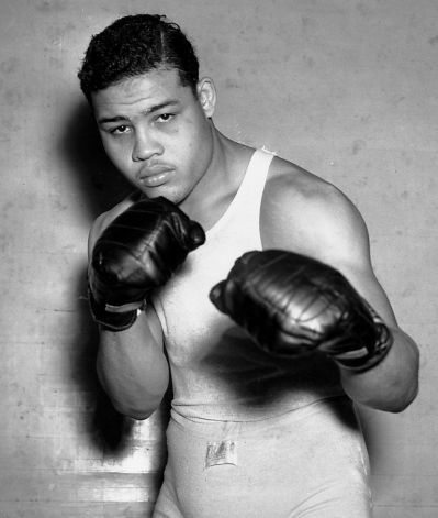 Fighter Joe Louis, nicknamed the Brown Bomber, poses in his boxing apparel in Pompton Lakes, N.J. on Jan. 24, 1937. Louis achieved the world... Idle Poses, Boxing Pose, Boxing Apparel, Joe Lewis, Boxer Aesthetic, Boxing Clothes, American Athletes, Joe Louis, Boxing History