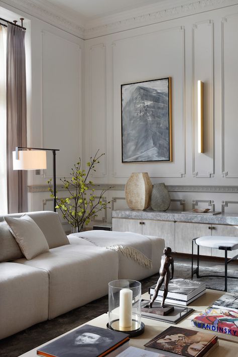 A custom handmade credenza lines one wall of this London drawing room by Janine Stone. The piece, covered in a fine crackle gesso, rests on a cast-bronze base and is topped with pale Moonrock marble from the quarries of northern Italy. The large-scale sofas in pale oyster velvet provide comfortable and inviting seating, and the cool color scheme sets a restrained mood for a client who wanted “to ensure the home creates a welcome retreat, conveying a sense of harmony and gentle calm.” Classic Interior, Kensington House, Design Salon, Decoracion Living, Trendy Living Rooms, Decoration Inspiration, Decor Minimalist, Living Room Grey, Contemporary Living Room