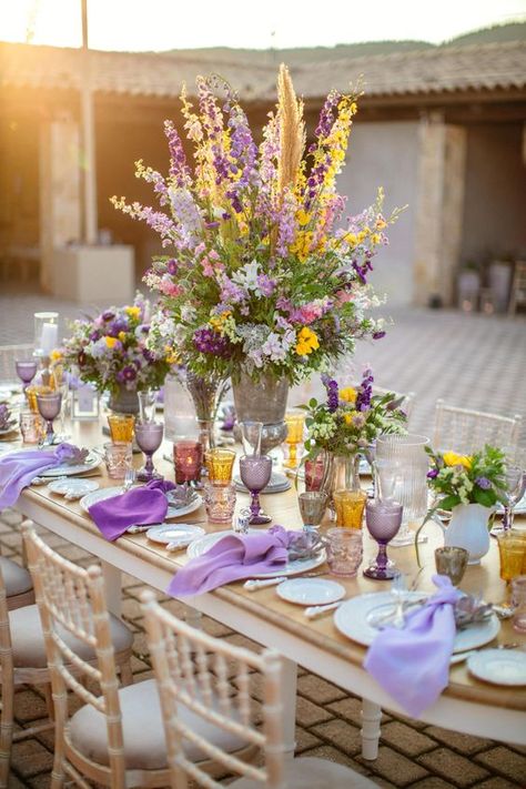 an exquisite table setting of lavender and yellow plus amber and grey touches with a very lush and textural centerpiece Yellow And Purple Wedding, Yellow Purple Wedding, Tropisk Fest, Purple Wedding Tables, Unique Wedding Table Decorations, Wedding Table Ideas, Rapunzel Wedding, Tangled Wedding, Ideas Aniversario