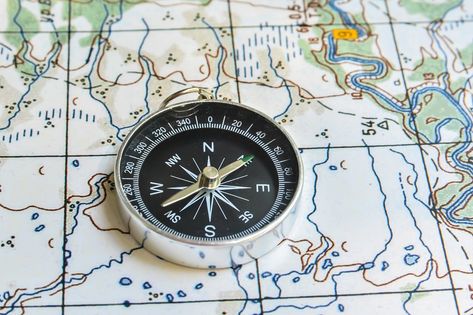 Compass and map. The magnetic compass is located on a topographic map. Compass, Magnetic Compass, Design Graphics, Topographic Map, Vector Design, Wall Clock, Magnets, Stock Photo, Clock