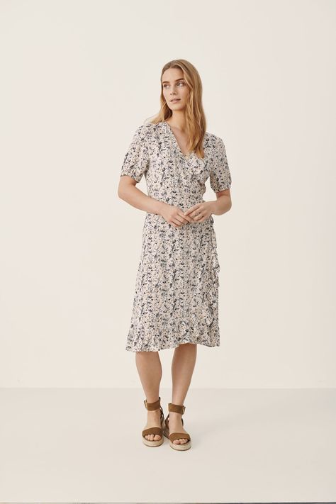 This dress by Copenhagen-based brand, Part Two, is made for traipsing in a field full of daisies! Wrap style dress with side tie. Cute paired with a sandals (for your besties's spring/summer wedding?) or sneakers for a daytime date with your girlfriends. Materials: 100% Viscose (EcoVero). Learn more about the EcoVero fabric here. Care: Gentle wash; do not bleach; cold iron; do not tumble dry; dry clean only Size Info: Model is 5'8" and is wearing a size 36/M. Size Guide | Shipping Policy