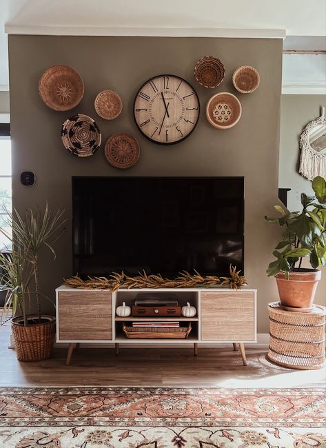 Bohemian Living Room Wall Clocks, Baskets On Wall Around Tv, Basket Wall Behind Tv, Boho Decor Tv Wall, Wall Clock Collage Ideas, Baskets Around Tv On Wall, Basket Wall Over Tv, Clocks In Bedroom Ideas, Living Room Wall Decor Ideas Boho Farmhouse