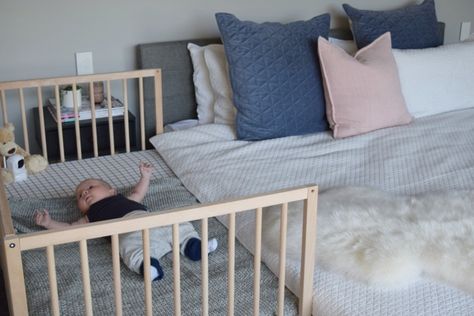 This IKEA hack where I attached a cot (without the side panel) to my bed has been the best idea EVER! I can reach over and feed little P in the middle of the night and it costs a fraction of those bassinets that attach to the side of your bed. It also means when he's big enough, I can just attach the other panel and voila, it's a cot and bassinet in one. Ikea Crib Hack Co Sleeper, Baby Bed Attached To Bed, Cot In Parents Room Ideas, Cot In Bedroom, Crib Attached To Bed, Small Room With Crib And Bed Ideas, Ikea Baby Bed Hack, Cot In Parents Room, Ikea Singular Crib Hack