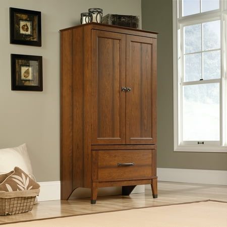 In the master suite or around the house, this armoire from the Carson Forge collection keeps any room stylish and tidy. Behind its double doors is a hidden storage area that includes a garment rod for hanging clothes along with a generous amount of wardrobe space for you to store anything from dresses and button up shirts to spare blankets and your collection of shoes. This clothes storage cabinet also features a large drawer that opens and closes on smooth metal runners for additional storage of the largest sweaters, the thickest denim, and the coziest linens. The simple design and charming style of this wardrobe cabinet make it a perfect fit for any room in your home in the bedroom, the entryway or even in the living room. This armoire with hanging rod looks good no matter where it stand Cabinet Making, Wardrobe Space, Collection Of Shoes, Wardrobe Cabinet, Large Drawer, Wardrobe Cabinets, Clothes Storage, Hanging Clothes, Large Sweaters