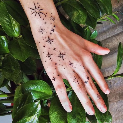 The stars have always held a special place in human history and imagination. From being used for navigation to inspiring countless myths and legends, ... Hand Tattoo Cute, Colorful Filler Tattoo, Filler Tattoo Ideas Gap Stars, Galaxy Hand Tattoos For Women, Star Stick N Poke Tattoos, Hidden Gem Tattoo, Tattoo Star Design, Star Tattoo Filler Ideas, Stars Hand Tattoos For Women