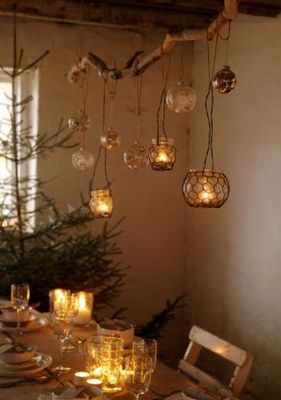 love this, with the branch. maybe have to do electric candles since flame ones would have to be surrounded by water.. Diy Branch Centerpieces, Candles And Lights, Branch Centerpieces, Bohemian Christmas, نباتات منزلية, Branch Chandelier, Deco Nature, Hanging Candles, The Ceiling