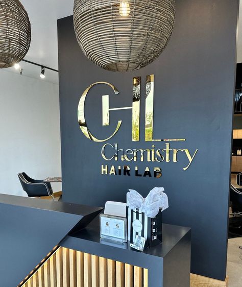 Signs For Home Office, Business Office Foyer Ideas Entrance, Reception Desk Back Wall Design, Medispa Design Interiors, Event Space Design Interiors, Business Front Desk, Black And Gold Accent Wall, Reception Area Decor, Small Lobby Design