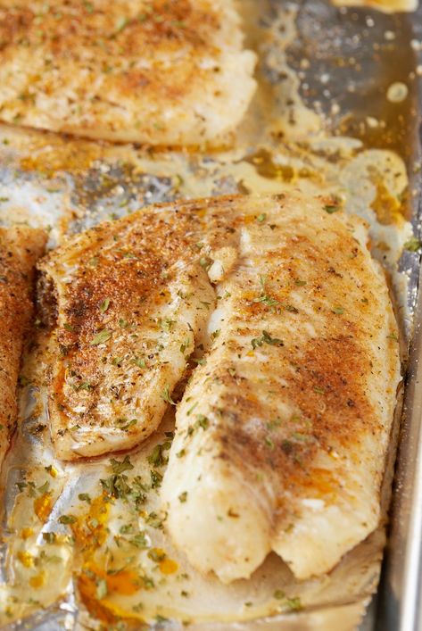Two baked fish fillets on a baking sheet ready to serve. Bake Fish Dinner Ideas, Oven Baked Basa Fish Recipes, Oven Baked White Fish, How To Cook Grouper Filets, Recipes For White Fish, Baked Cod Fillet Recipes, White Fish Baked Recipes, Oven Baked Basa Fillets, How To Cook Basa Fillets
