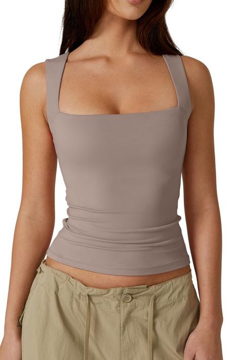 PRICES MAY VARY. Exceptionally Soft and Stretchy Fabric: Offer yourself the luxury of supreme comfort with our QINSEN sleeveless square-neck top. Crafted from a high-quality blend that's both delicately soft and impressively stretchy, this top promises a snug fit that gracefully accommodates your movements throughout the day. Elegantly Minimalist Design: Embracing a minimalist and body-positive design philosophy, our elegantly form-fitting top highlights your natural silhouette with its sleek pr Dirndl, Double Layer Tank Top, White Suspenders, Form Fitting Tops, Layered Tank Top, Square Neck Top, Layering Tanks, American Women, Womens Vest