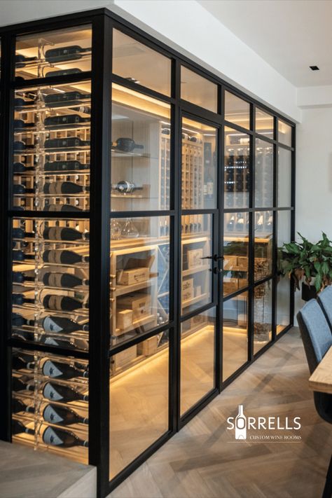 A Sorrells wine room with a black frame and door to finish Wine Rack In Living Room, Double Sided Glass Wine Wall, In House Wine Cellar, Corner Glass Wine Room, Wine Feature Wall Interior Design, Wine Cellar Home Design, Modern Farmhouse Wine Cellar, Wine Room Lighting Ideas, Walk In Wine Fridge