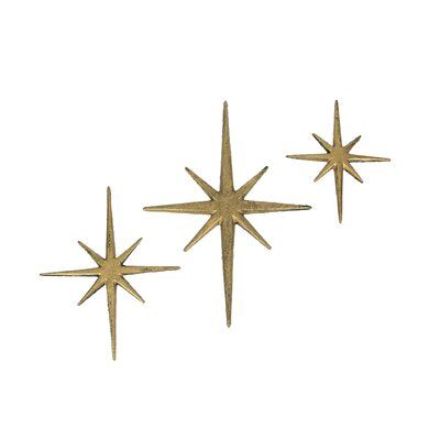 This trio of 8 pointed compass stars adds a wonderful Mid-Century modern touch to your indoor or outdoor decor. Crafted of cast iron, the stars feature an antiqued metallic gold enamel finish to give them a great aged look. The large star measures 8.75 inch long, 0.25 inch wide, 12 inch high; the medium star measures 7 inch long, 0.25 inch wide, 8.75 inch high; and the small star measures 5.75 inch long, 0.25 inch wide, 6.75 inch high. Hang them together or separately for a perfect accent to vin Starburst Wall Decor, Star Wall Decals, Stars Wall Decor, 3d Wall Decor, Star Wall Art, Yellow Home Decor, Accent Wall Decor, Metal Stars, Abstract Wall Decor