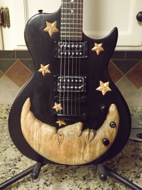 Luna Guitar I carved with a moon and stars motif Cute Guitar Accessories, 70s Guitar Aesthetic, Decorated Acoustic Guitar, Cool Trinkets, Cute Guitars, Guitar Painting Ideas, Aesthetic Instruments, Cool Guitar Designs, Acoustic Guitar Aesthetic