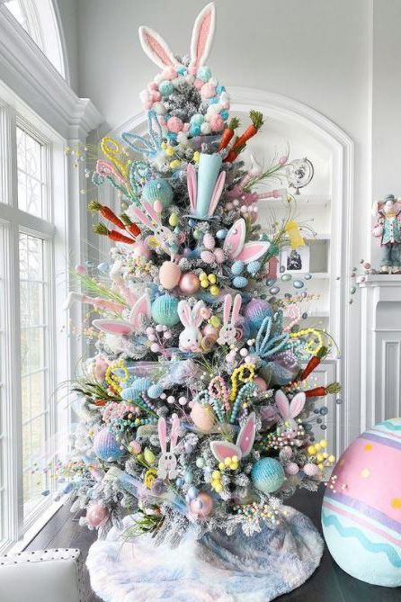 This Easter tree is an explosion of color. Dress up a flocked artificial tree for spring by tucking faux egg branches and pastel beads into the boughs. Add a few stuffed bunnies, pastel ornaments, and paper carrots for a colorful mix. #eastertree #eastertreeideas #easterdecorations #bhg Easter Egg Garland, Easter Outdoor, Easter Craft Decorations, Easter Tree Decorations, Easter Decorations Dollar Store, Easter Inspiration, Easter Decorations Christian, Easter Decorations Vintage, Easter Decorations Diy Easy