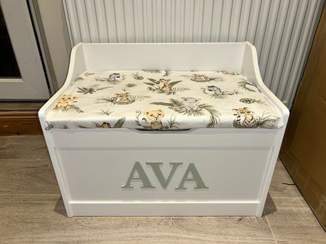 ⭐️JANUARY DELIVERY⭐️ Please only order if you are prepared to wait. Wooden personalised toy box with safari cushion seat, soft close hinge, personalised toy box name, book or toy storage.  Grey star fabric Personalised toy box, cushion top, named box Lots of other fabric available.  Soft close hinge. Fixed cushion top. Overall: Width 62cm x Depth 40cm x Height 46.60cm Lid: Width 58.5cm x Depth 38cm x Height 1.2cm Hand painted wooden letters. Any fabric can be done. You can choose from any listin Toy Box With Seat, Toy Box Ideas, Diy Toy Box Plans, Painted Toy Boxes, Boys Toy Box, Toy Box Plans, Painted Wooden Letters, Toy Storage Chest, Gender Neutral Toys