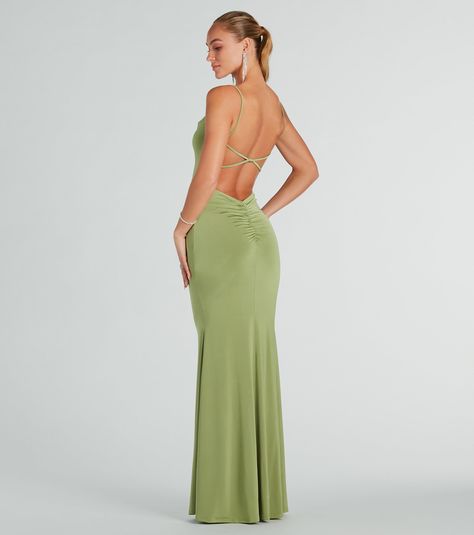 Simply chic, the Anya strappy open-back mermaid dress will turn heads at your next formal event. Designed with a sleek and stretchy knit fabric, she features a sleeveless cowl neckline, spaghetti straps, an alluring open back with a cross-back strappy design, lower back ruching to accentuate your curves, and a floor-length hem with a stunning mermaid silhouette. Style this formal long dress with dainty duster earrings for a subtle hint of glamour.Fit & FeaturesSleeveless cowl neckline, spagh Simple Open Back Prom Dress, Prom Dresses No Back, Open Back Prom Dress Fitted, Prom Dresses Sage, Low Back Dress Formal, Green Wedding Guest Dress, Sage Prom Dress, Silk Backless Dress, Sage Green Prom Dress