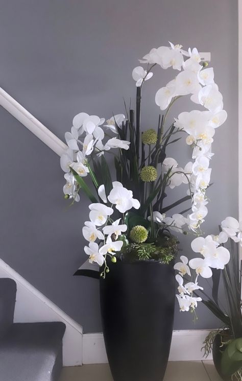 Fabulous luxury real touch faux orchids in a tall pot with allium, leaves and greenery. Tall Orchid Arrangement, Plants In Vases Decor, Tall Floor Vase Flower Arrangements, Indoor Vase Decor, Floor Vase Flower Arrangements, Big Vase With Flowers, Floor Vase Arrangement, Silk Orchids Arrangements, Tall Floral Arrangements