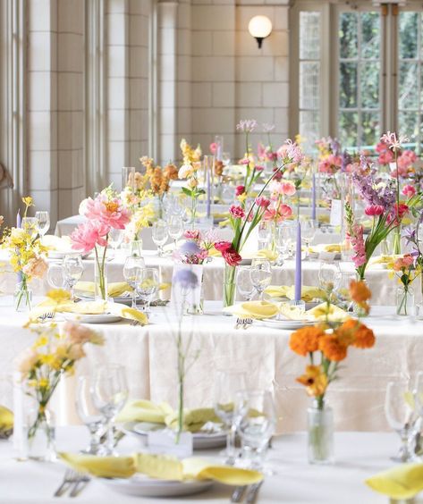 These colors are a dream 😍 This color palette is perfect for a romantic and whimsical summer wedding. Get creative when adding color to your tablescape including the candles, glassware and napkins to compliment these gorgeous arrangements. #Alinato #AlinatoEvents #WeddingInspo #WeddingTablescapes #weddingtable #weddingseason #weddingplanning #weddingtrends #tables #weddingdecor #decor #weddinginspiration #weddingphotography #weddings #nycweddings #wedding #theknot #vogueweddings #brides Table Centerpieces Wedding Colorful, Colourful Flower Wedding Table, Minimalist Spring Wedding Decor, Colorful Floral Tablescape, Colorful Table Linens Wedding, Royal Wedding Table Decor, Garden Party Wedding Palette, Colourful Candles Wedding, Circle Table Wedding Decor Colorful