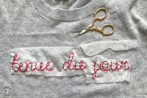 Learn how to make a DIY Embroidered sweater with a fun french quote on it. Includes free embroidery pattern for the quote. A clever way to refashion an old sweater. #DIYEmbroidery #DIYFashion #embroideredsweater #tutorial Couture, Embroidery Sweaters Diy, Hand Stitched Sweatshirt Diy, Chain Stitch Embroidery Sweater, Cross Stitch On Sweater, Embroider Sweater Diy, Chain Stitch Name Sweater, Diy Embroidered Name Sweater, How To Hand Embroidery On Clothes
